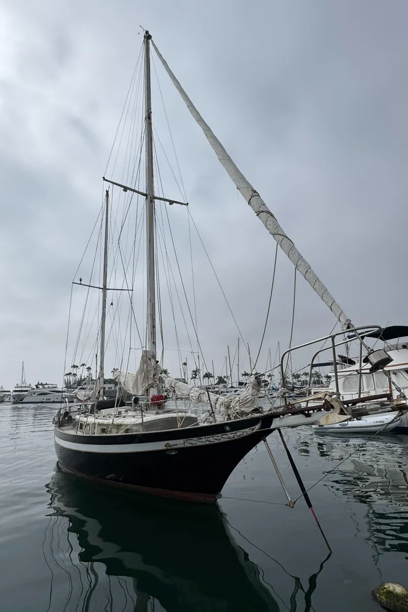 Slide: The Image of 1979 Cheoy Lee Bill Luders Clipper Ketch sailboat docked in a marina. - 2