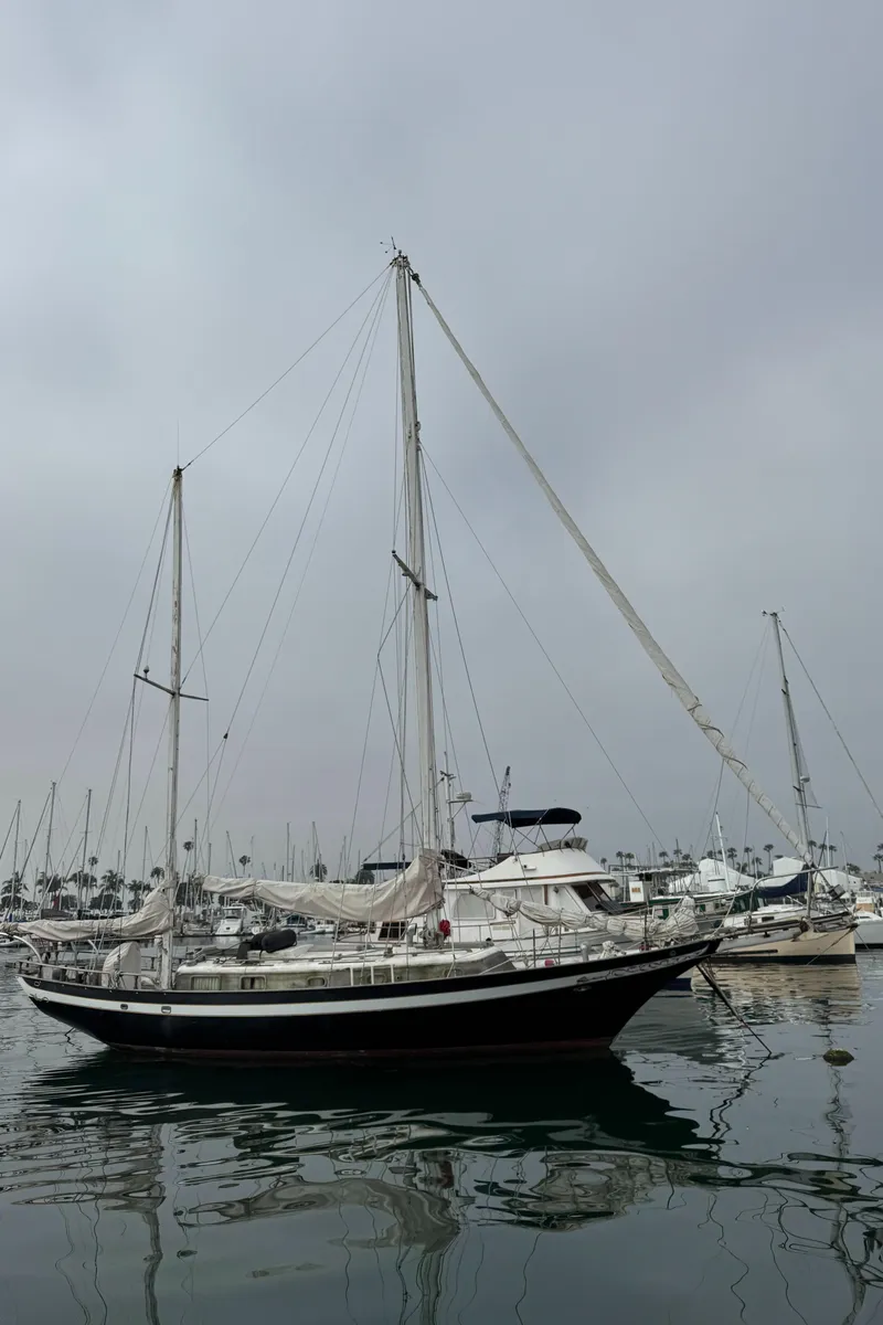 Slide: The Image of 1979 Cheoy Lee Bill Luders Clipper Ketch sailboat docked in a marina. - 4