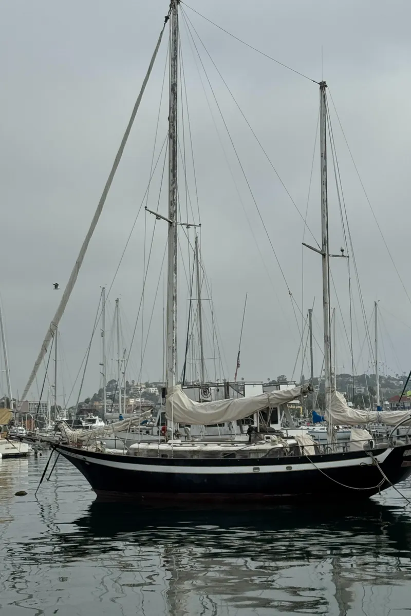 Slide: The Image of 1979 Cheoy Lee Bill Luders Clipper Ketch sailboat docked in a marina. - 5