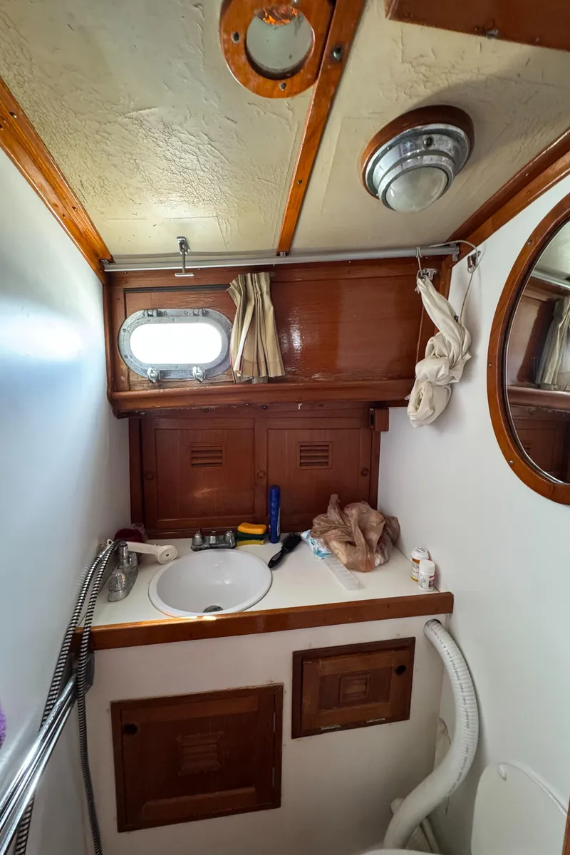 Slide: The Image of 1979 Cheoy Lee Bill Luders Clipper Ketch bathroom with wooden accents and nautical decor. - 8