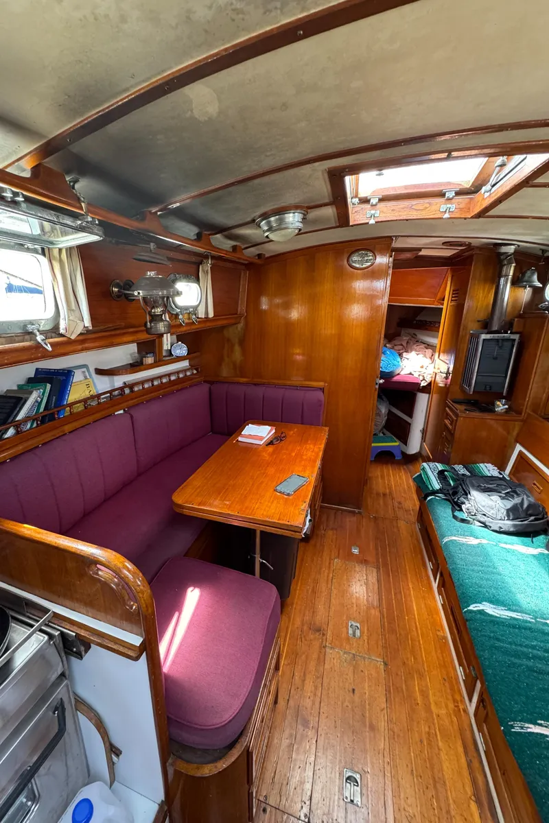 Slide: The Image of 1979 Cheoy Lee Bill Luders Clipper Ketch interior with wood finish and seating area. - 9