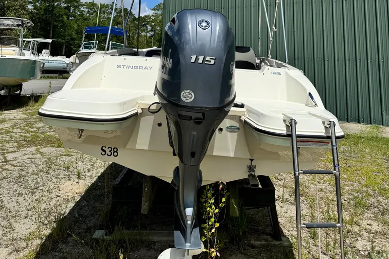 Slide: The Image of 2017 Stingray 182 SC boat with Yamaha 115 outboard motor, parked outdoors. - 10