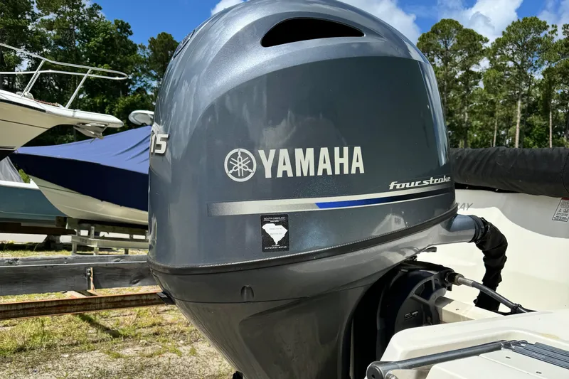 Slide: The Image of Yamaha outboard motor on 2017 Stingray 182 SC boat, parked outdoors. - 12