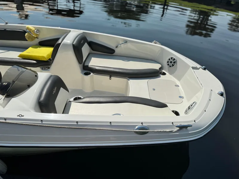 Slide: The Image of 2017 Stingray 182 SC boat interior with seating, on calm water. - 18