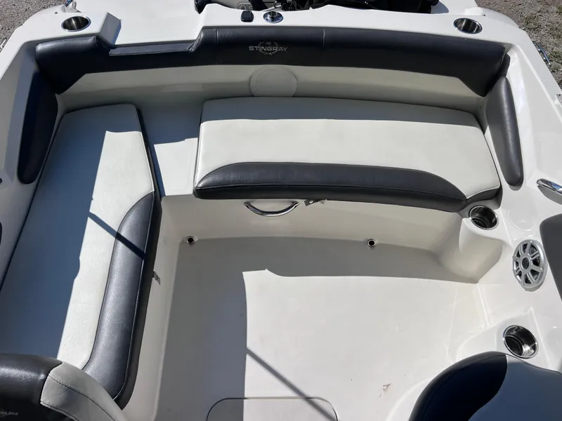 Slide: The Image of 2017 Stingray 182 SC boat interior with white and black seating. - 20