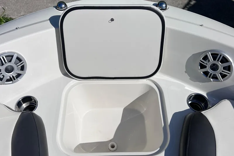 Slide: The Image of 2017 Stingray 182 SC boat interior with storage compartment and speakers. - 22