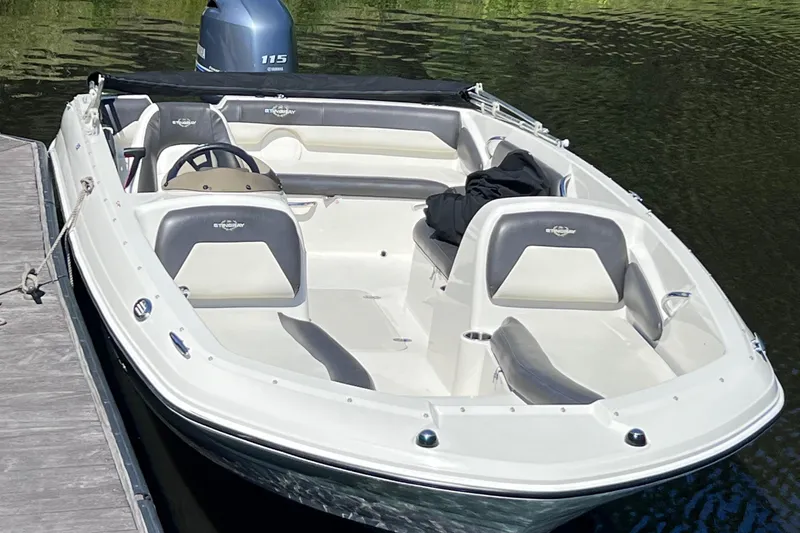 Slide: The Image of 2017 Stingray 182 SC boat docked on calm water. - 23