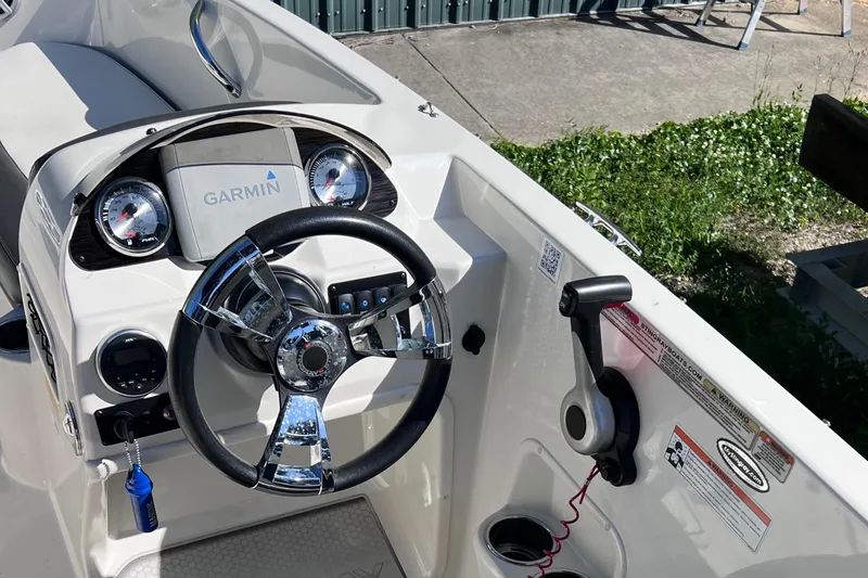 Slide: The Image of 2017 Stingray 182 SC boat dashboard with Garmin navigation system and steering wheel. - 24