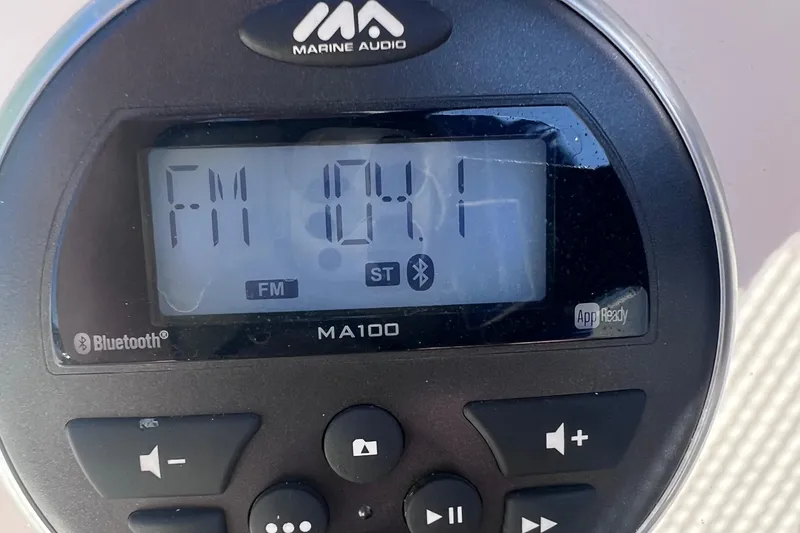 Slide: The Image of Marine audio system displaying FM 94.1, Bluetooth enabled, on a 2017 Stingray 182 SC. - 27