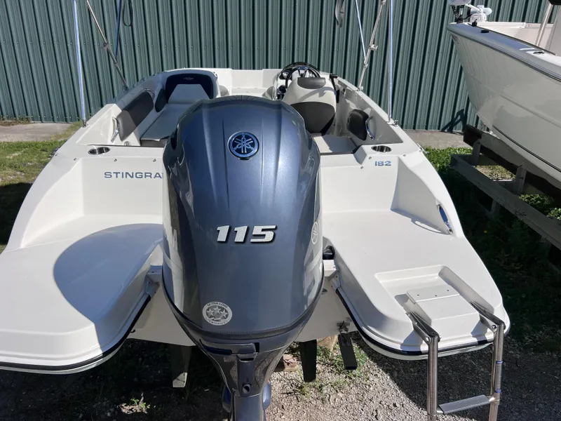 Slide: The Image of 2017 Stingray 182 SC boat with Yamaha 115 outboard motor, parked outdoors. - 5