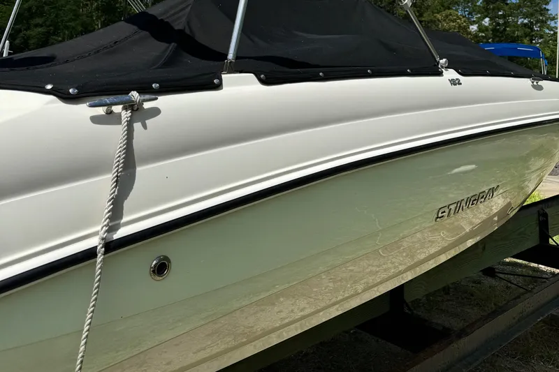 Slide: The Image of 2017 Stingray 182 SC boat with black cover on trailer. - 6