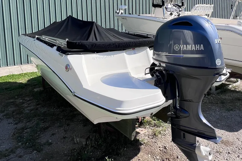 Slide: The Image of 2017 Stingray 182 SC boat with Yamaha outboard motor, covered and parked outdoors. - 9