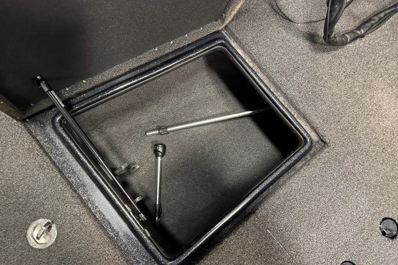 Slide: The Image of Open storage compartment in 2022 Nitro ZV21 boat with metal rods inside. - 20