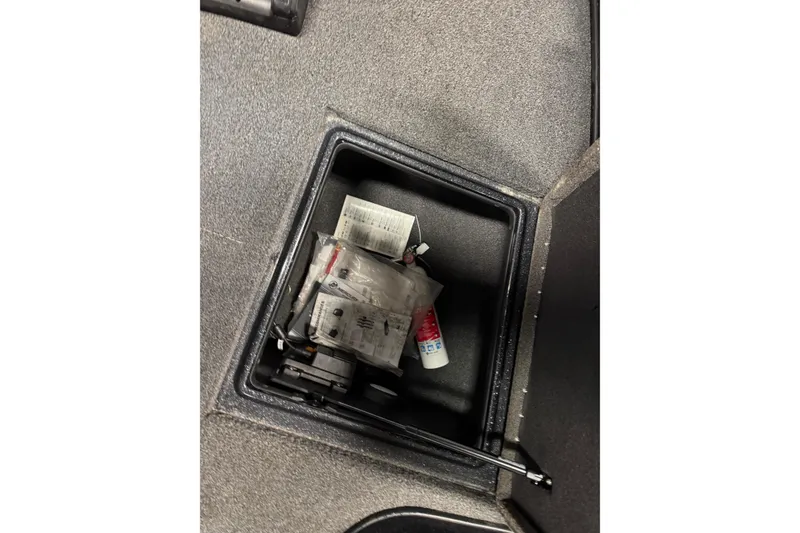 Slide: The Image of Storage compartment in 2022 Nitro ZV21 boat with various items inside. - 21