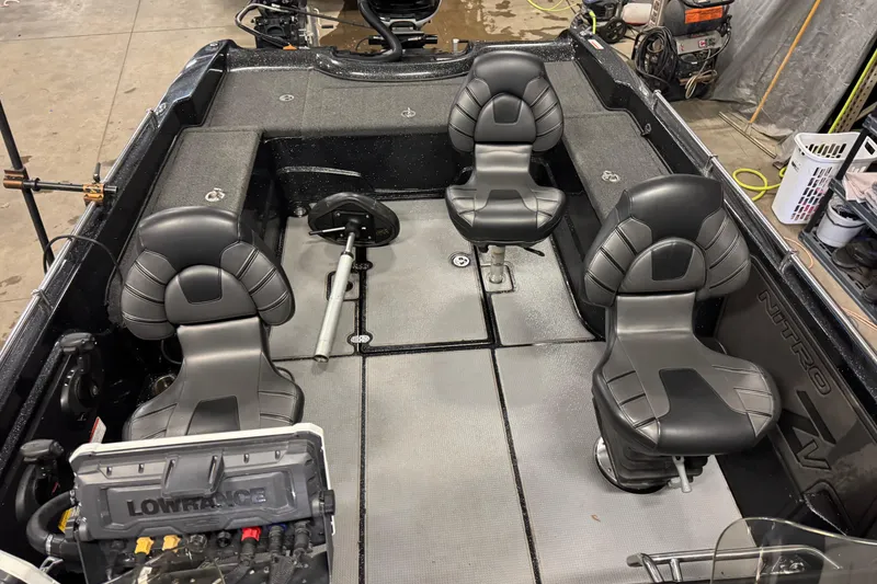 Slide: The Image of Interior of a 2022 Nitro ZV21 boat with four black seats and fishing equipment. - 22