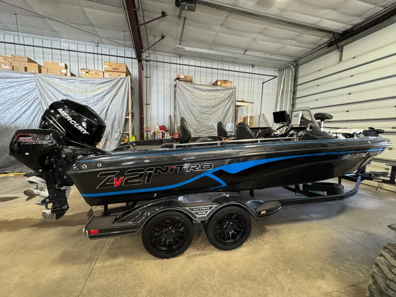 Slide: The Image of 2022 Nitro ZV21 boat with Mercury engine in a garage setting. - 3