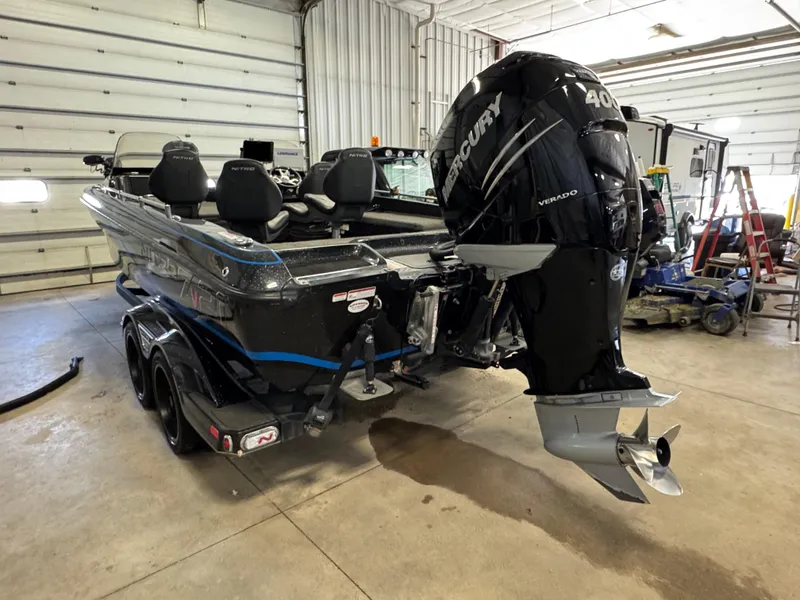 Slide: The Image of 2022 Nitro ZV21 boat interior with black seats and storage compartments. - 6