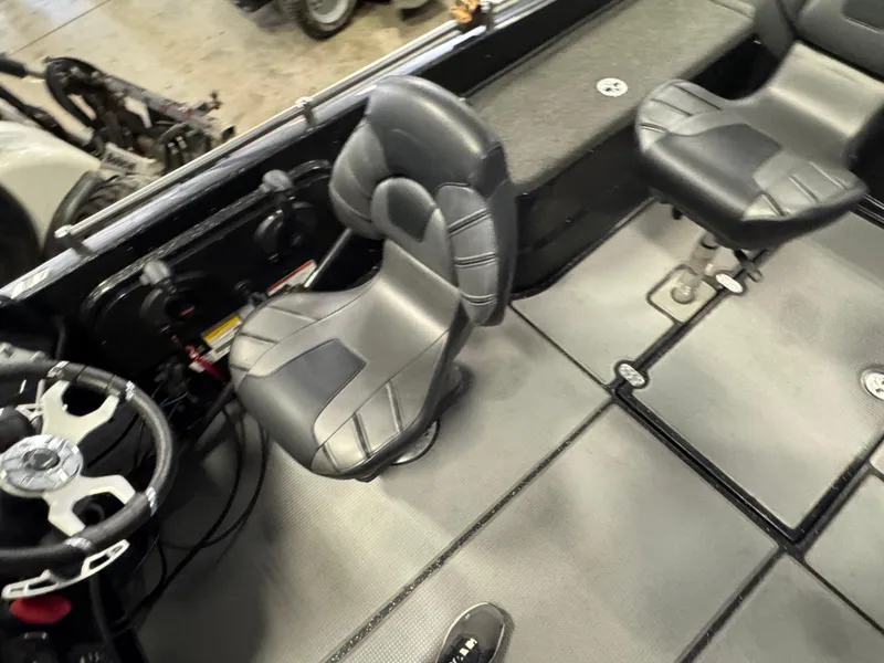 Slide: The Image of Interior of a 2022 Nitro ZV21 boat featuring a steering wheel and seat. - 9