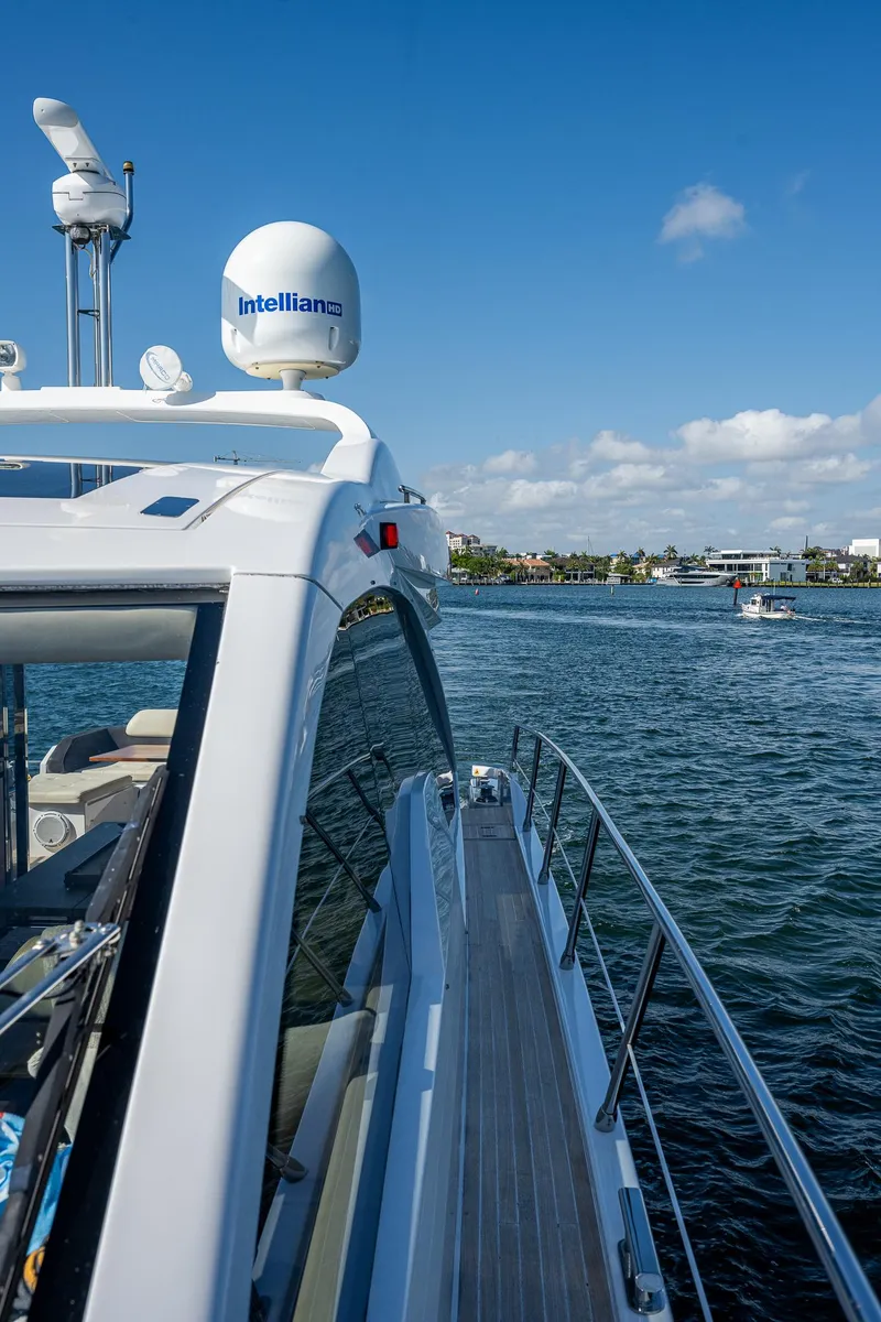 Slide: The Image of 2014 Azimut 55S yacht cruising on a sunny day, showcasing sleek design and advanced technology. - 17