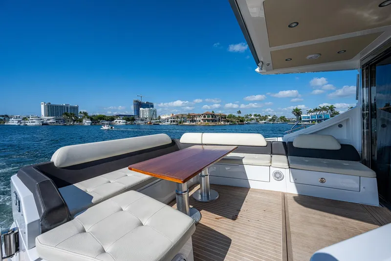 Slide: The Image of Luxurious 2014 Azimut 55S yacht deck with seating, table, and scenic waterfront view. - 19