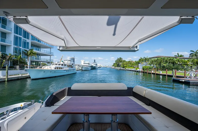 Slide: The Image of Luxurious 2014 Azimut 55S yacht with elegant seating, docked in a scenic marina. - 21