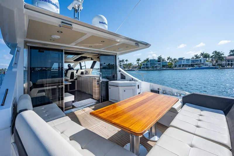 Slide: The Image of Luxurious 2014 Azimut 55S yacht with spacious outdoor seating and scenic waterfront view. - 23