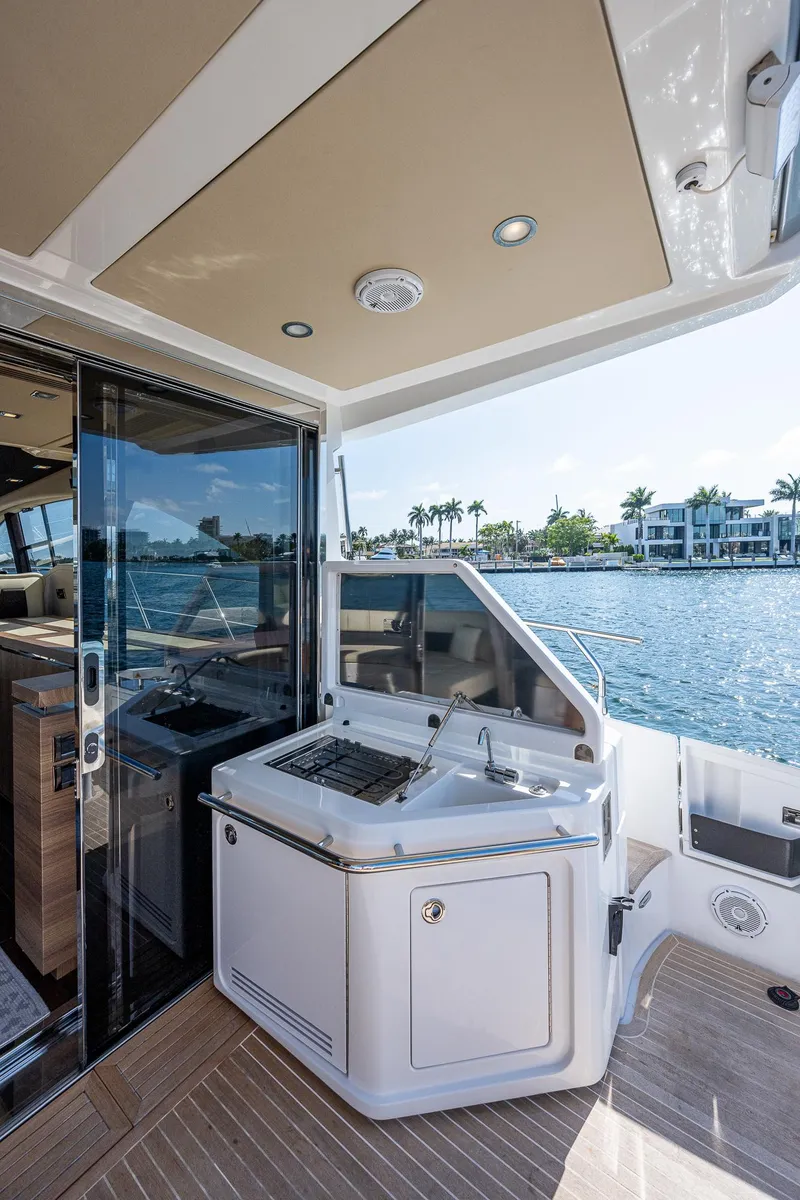 Slide: The Image of 2014 Azimut 55S yacht deck with outdoor kitchen, overlooking waterfront homes. - 24