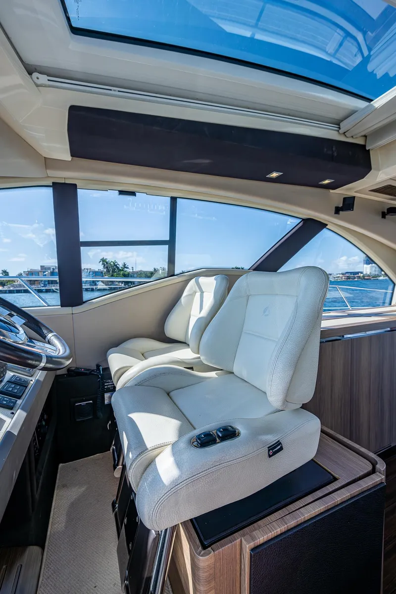 Slide: The Image of Luxurious interior of a 2014 Azimut 55S yacht with plush seating and panoramic windows. - 32
