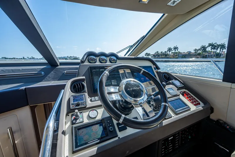 Slide: The Image of Cockpit of 2014 Azimut 55S yacht with modern navigation controls and steering wheel. - 36
