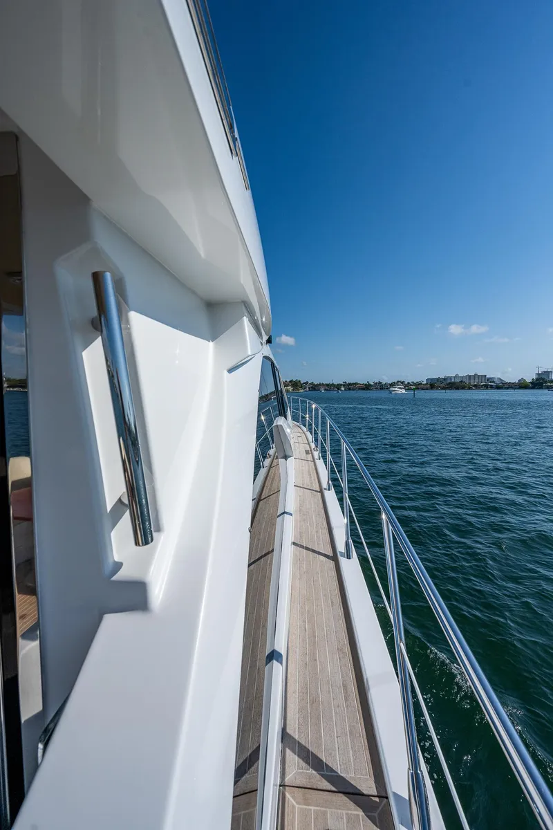 Slide: The Image of 2014 Azimut 55S yacht side view with ocean backdrop and clear blue sky. - 9