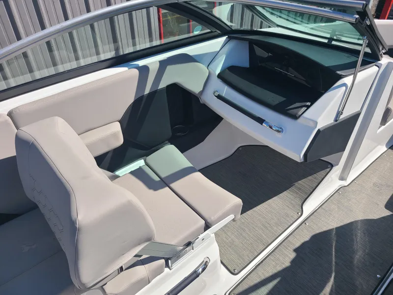 Slide: The Image of 2023 Four Winns H2 boat interior with modern seating and dashboard design. - 11