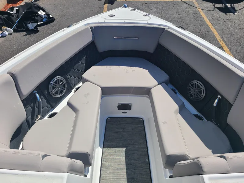 Slide: The Image of 2023 Four Winns H2 boat interior with cushioned seating and built-in speakers. - 7