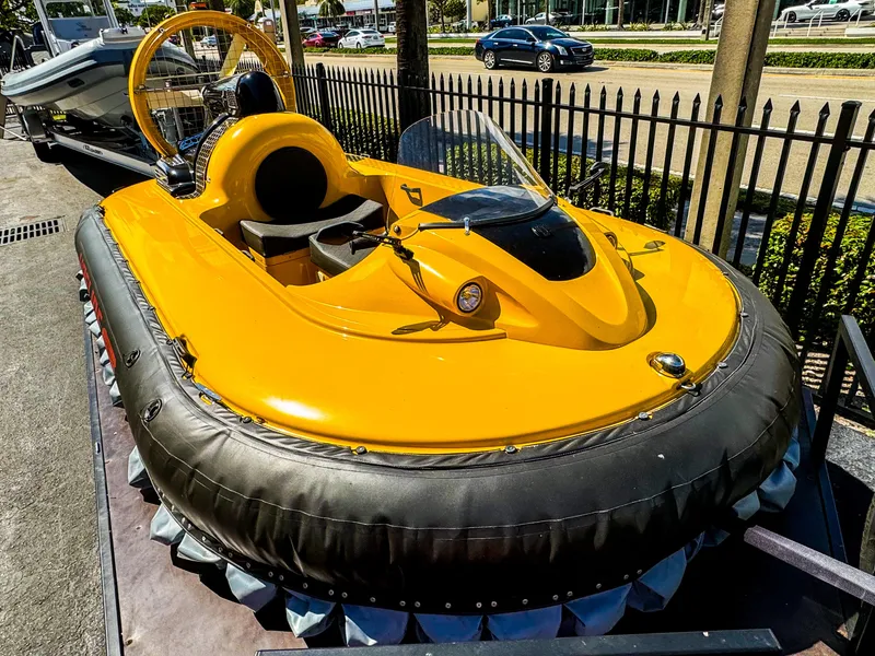 Slide: The Image of 2024 Airboat Airslide A33, bright yellow hovercraft, displayed outdoors. - 1