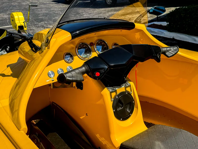 Slide: The Image of 2024 Airboat Airslide A33 cockpit with yellow dashboard and steering controls. - 7
