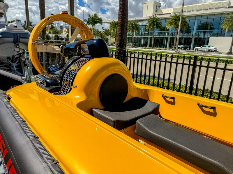 Slide: The Image of 2024 Airboat Airslide A33, yellow, parked near a modern building with palm trees. - 8