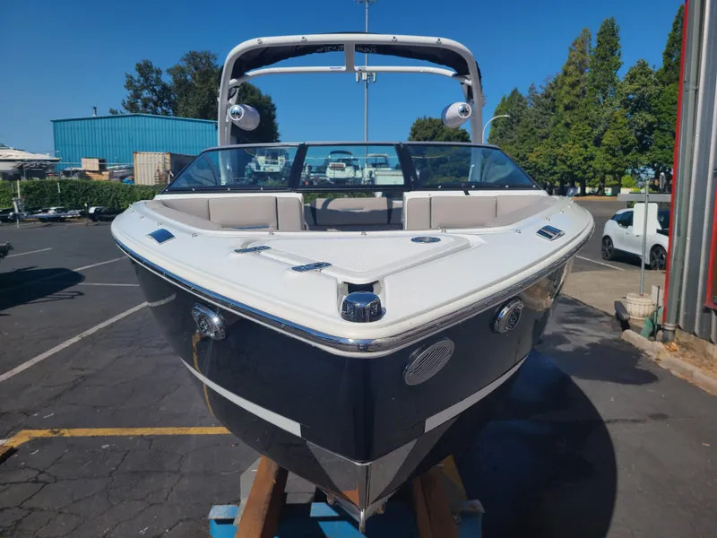 Slide: The Image of 2023 Four Winns H2 boat with sleek design, docked outdoors on a sunny day. - 2