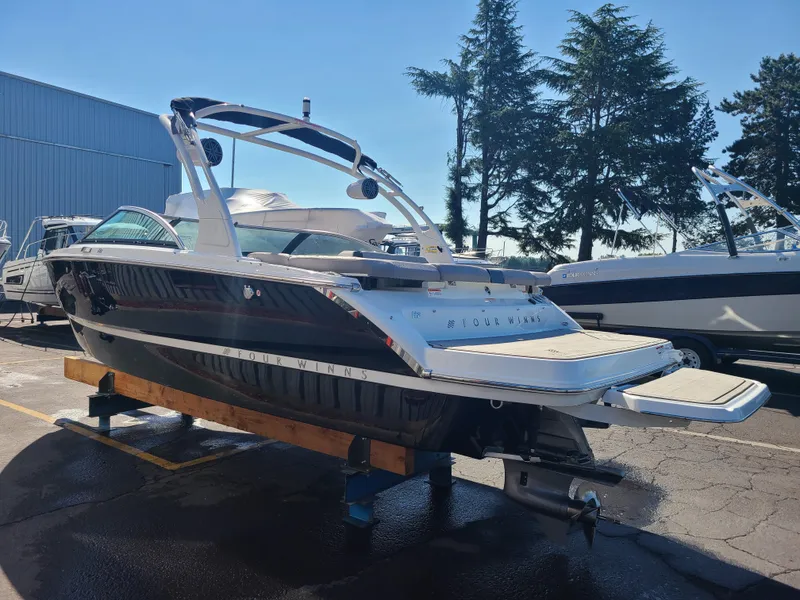 Slide: The Image of 2023 Four Winns H2 boat on display, featuring sleek design and modern amenities. - 5