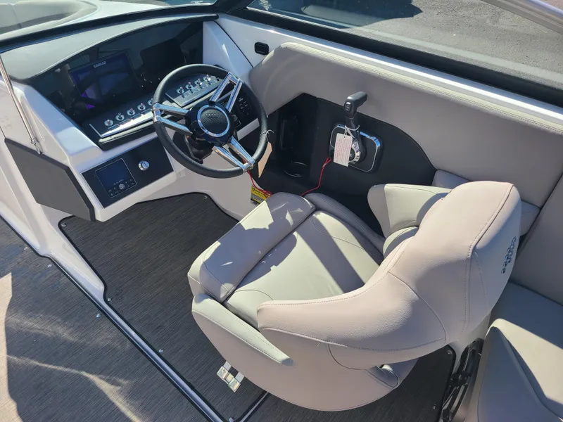 Slide: The Image of 2023 Four Winns H2 boat interior with steering wheel and control panel. - 9