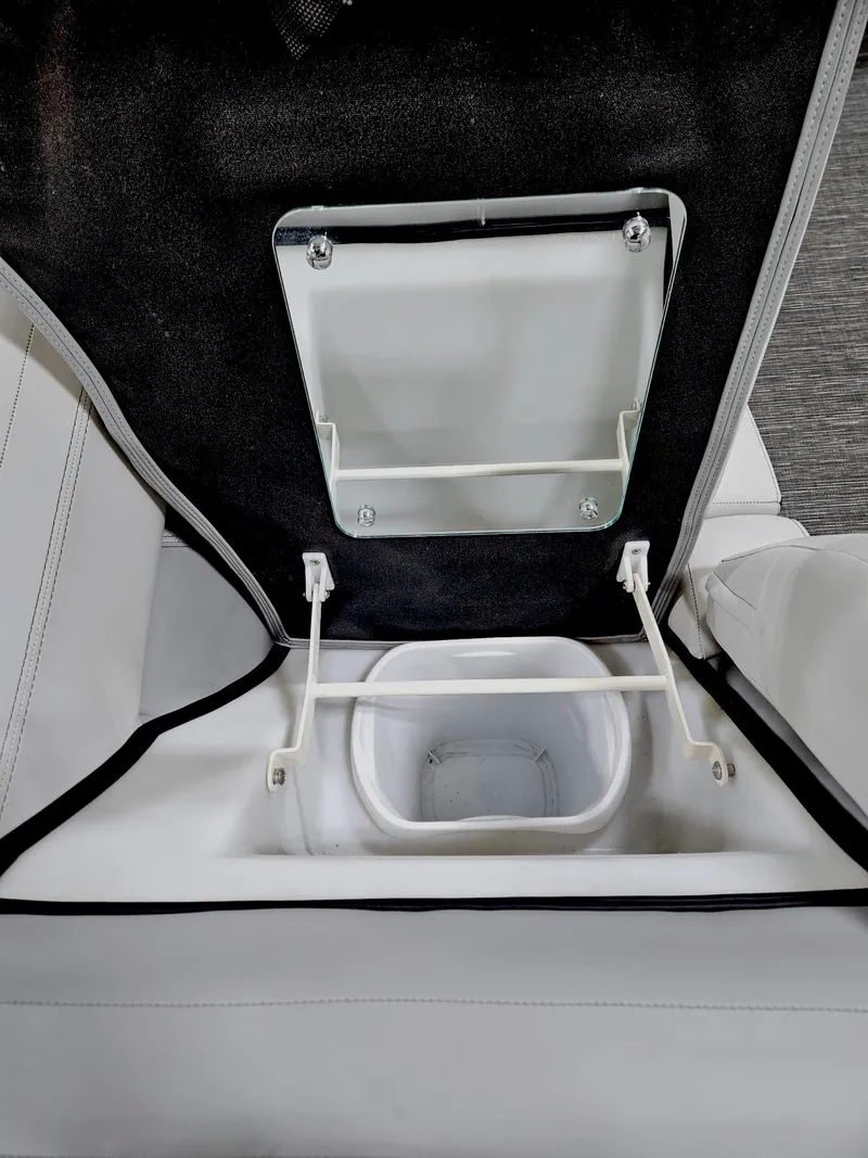 Slide: The Image of 2023 Viaggio Diamante U seat storage compartment with open lid and white interior. - 14