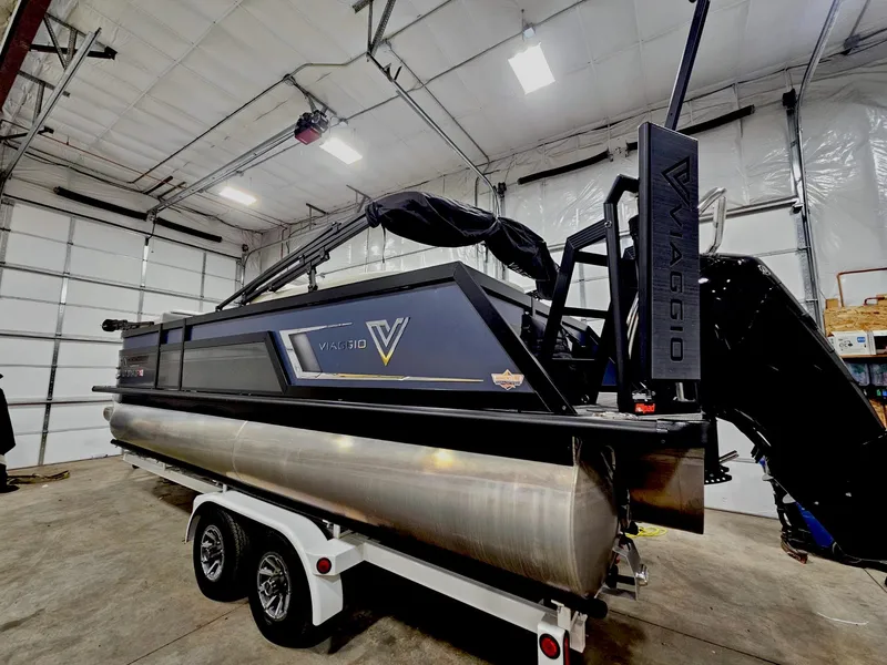 Slide: The Image of 2023 Viaggio Diamante U pontoon boat in a garage on a trailer. - 2