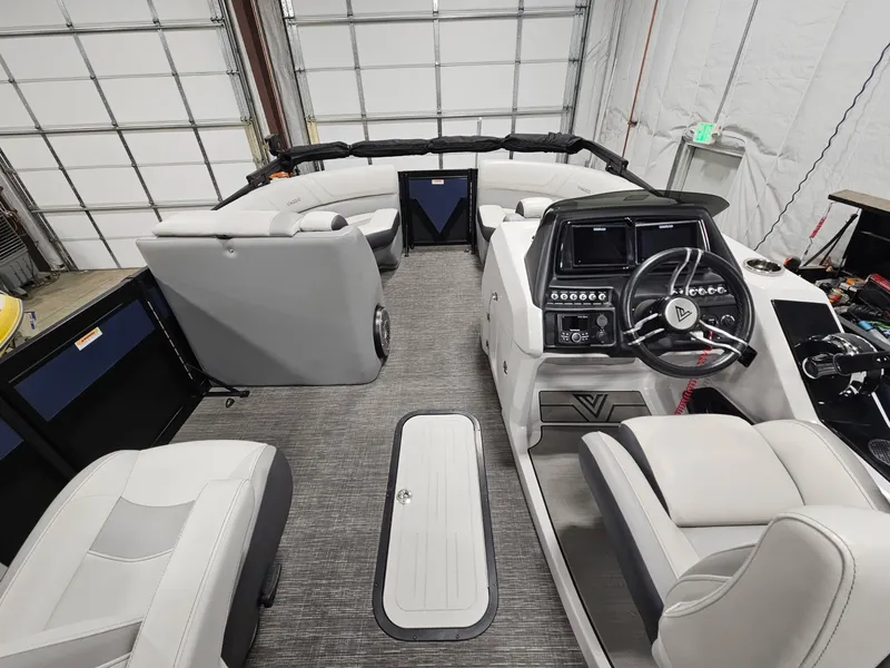 Slide: The Image of 2023 Viaggio Diamante U boat interior with modern dashboard and seating in a garage. - 6