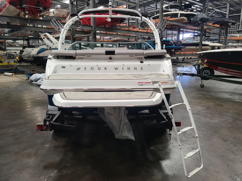 Slide: The Image of 2023 Four Winns H2 boat in storage with ladder extended. - 3