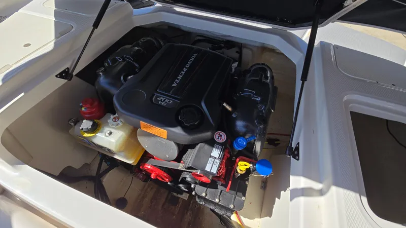 Slide: The Image of 2019 Chaparral 21 H2O Sport engine compartment with visible components. - 11