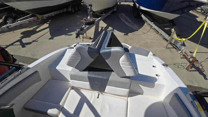 Slide: The Image of 2019 Chaparral 21 H2O Sport boat interior with white and gray seating. - 14