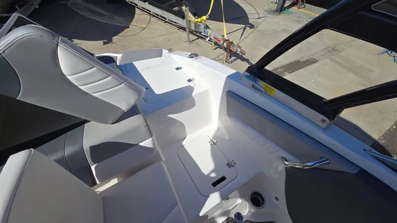 Slide: The Image of 2019 Chaparral 21 H2O Sport boat interior with seating and storage compartments. - 15