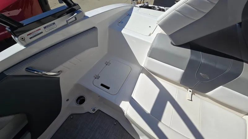 Slide: The Image of 2019 Chaparral 21 H2O Sport boat interior with white and gray seating. - 16