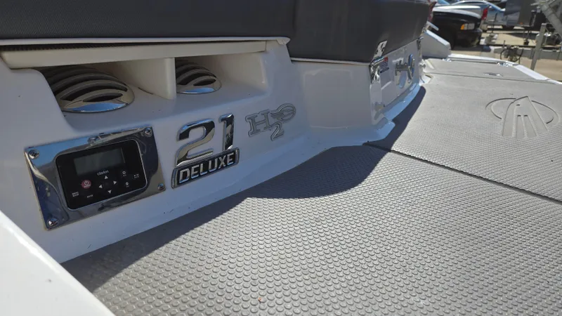 Slide: The Image of 2019 Chaparral 21 H2O Sport boat deck with deluxe branding and control panel. - 18