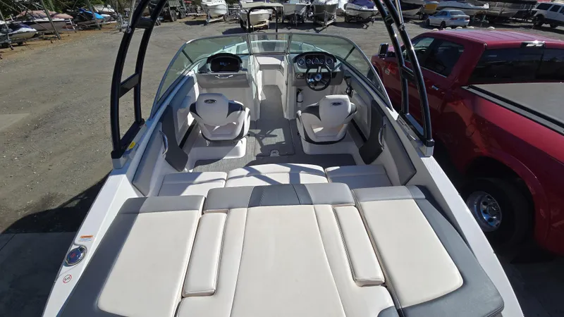 Slide: The Image of 2019 Chaparral 21 H2O Sport boat interior with seating and dashboard view. - 19
