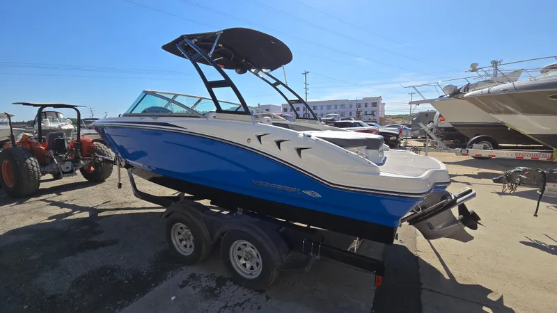 Slide: The Image of 2019 Chaparral 21 H2O Sport boat on trailer in a marina setting. - 2