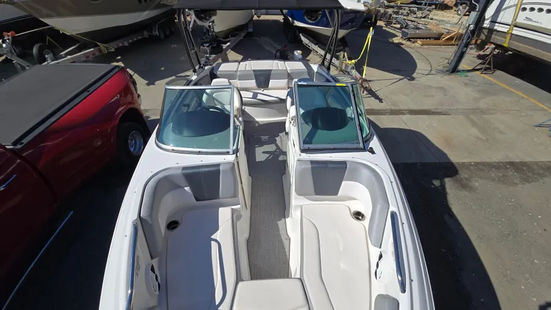 Slide: The Image of 2019 Chaparral 21 H2O Sport boat, aerial view, docked, with open seating layout. - 24